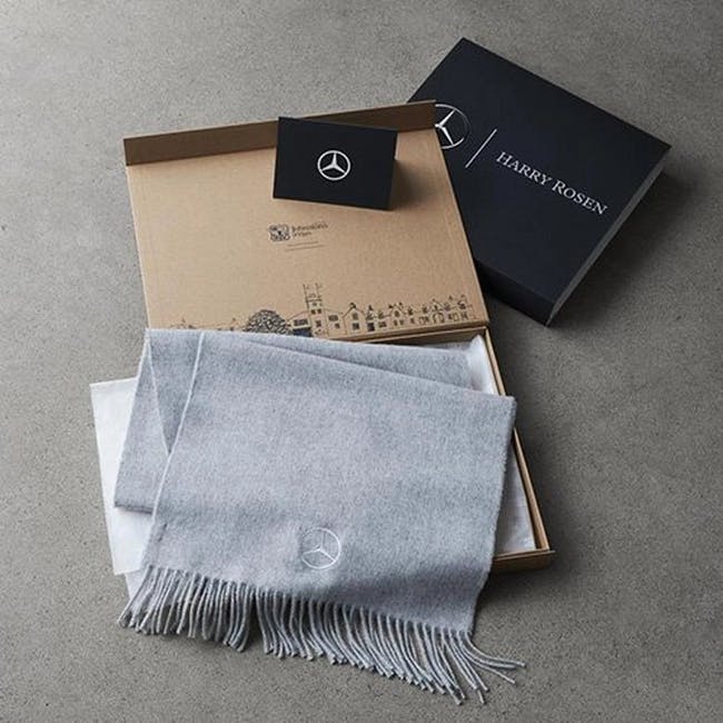 open box with folded scarf and gift card